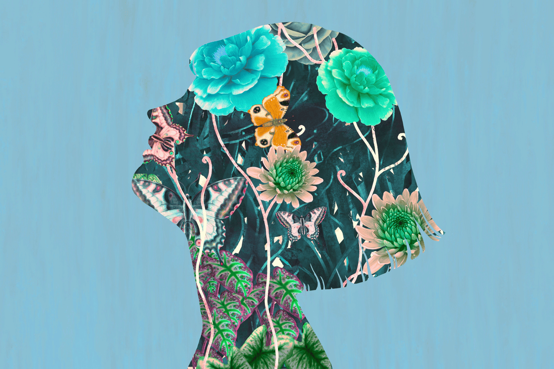 Paper collage artwork in the shape of a woman's silhouette filled with flowers, butterflies, foliage and layered botanical imagery against a blue background.