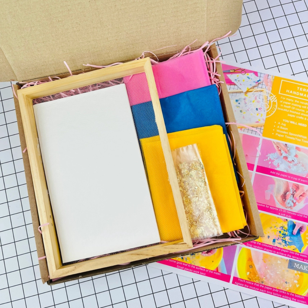 Contents of The Edinburgh Craft Club Terrazzo Paper Making Kit including mould and deckle, sponge, pulp and papermaking tools.