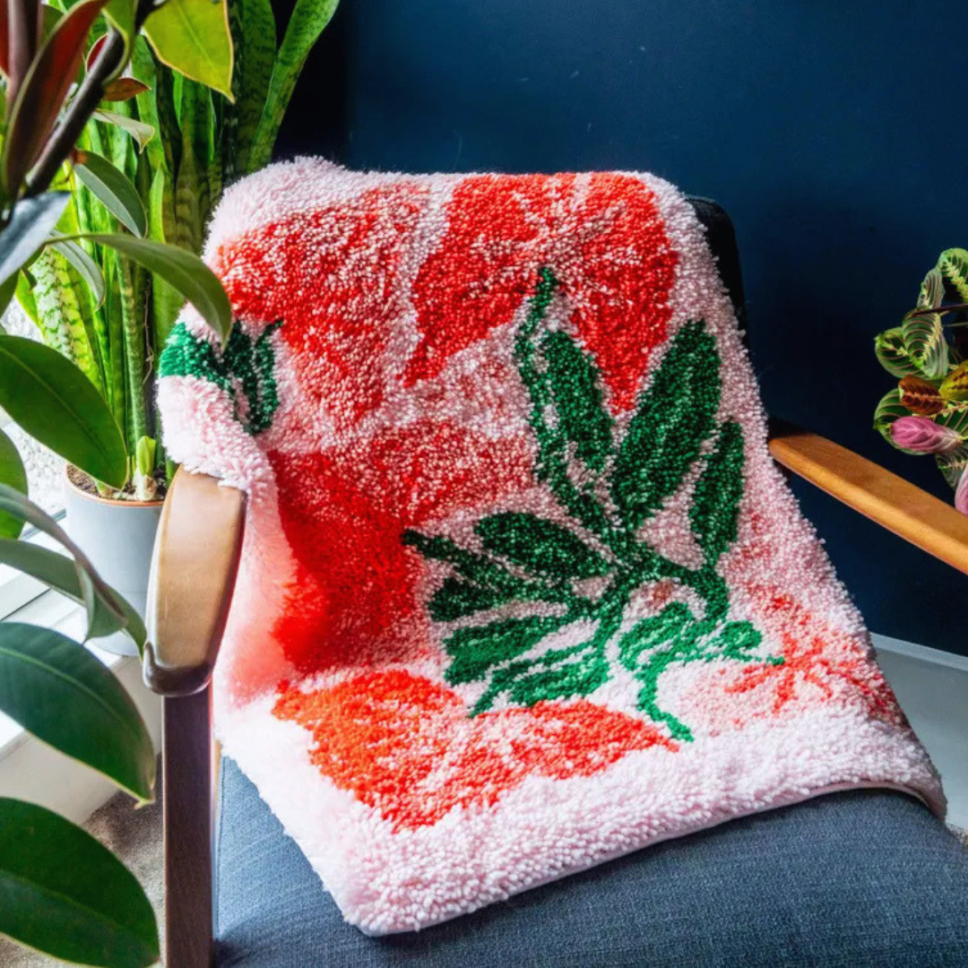 Close-up of the finished tropical leaf latch hook rug showing textured yarn detail and vibrant colours.