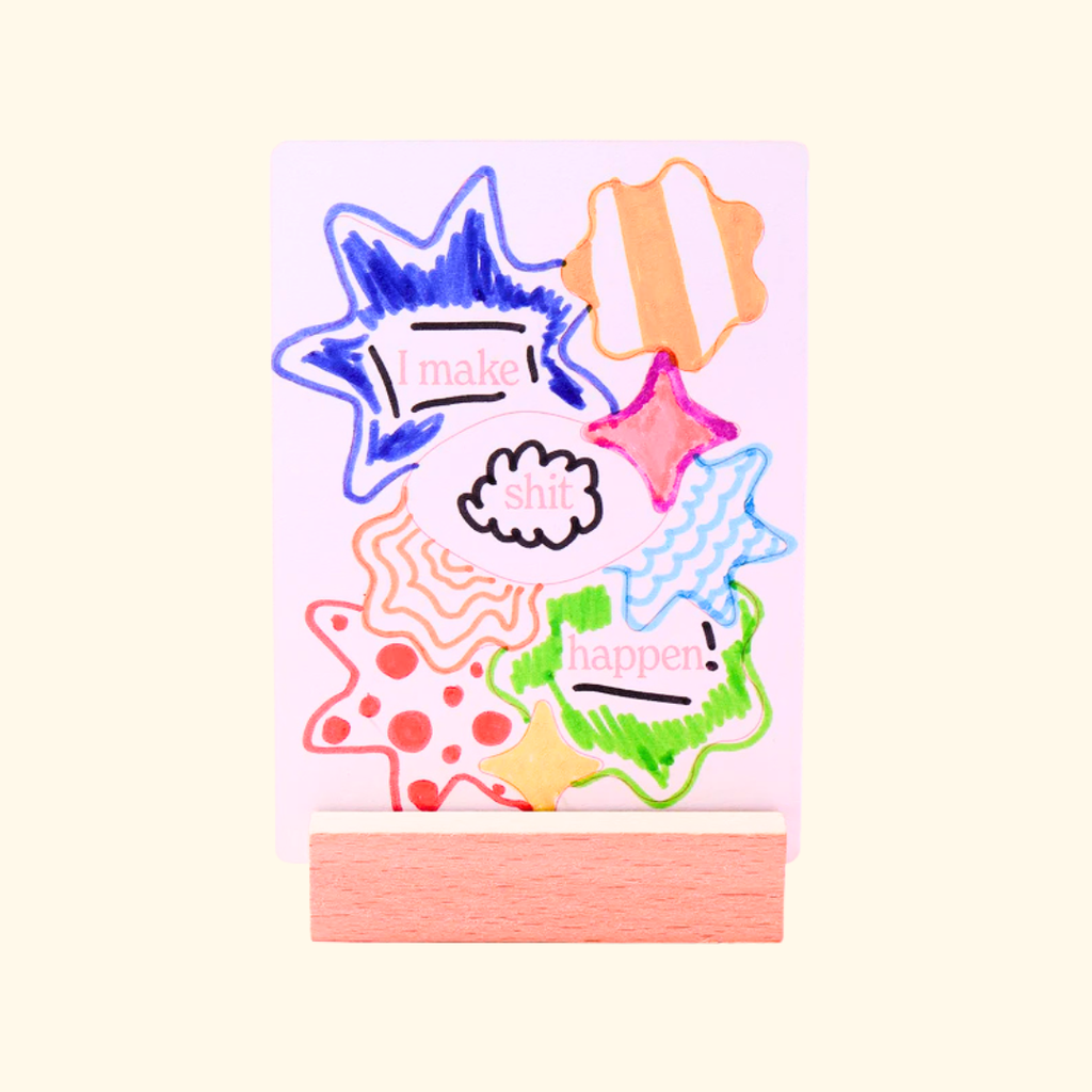 Close up of illustrated affirmation cards from the Journey Of Something colouring kit displayed on a wooden stand