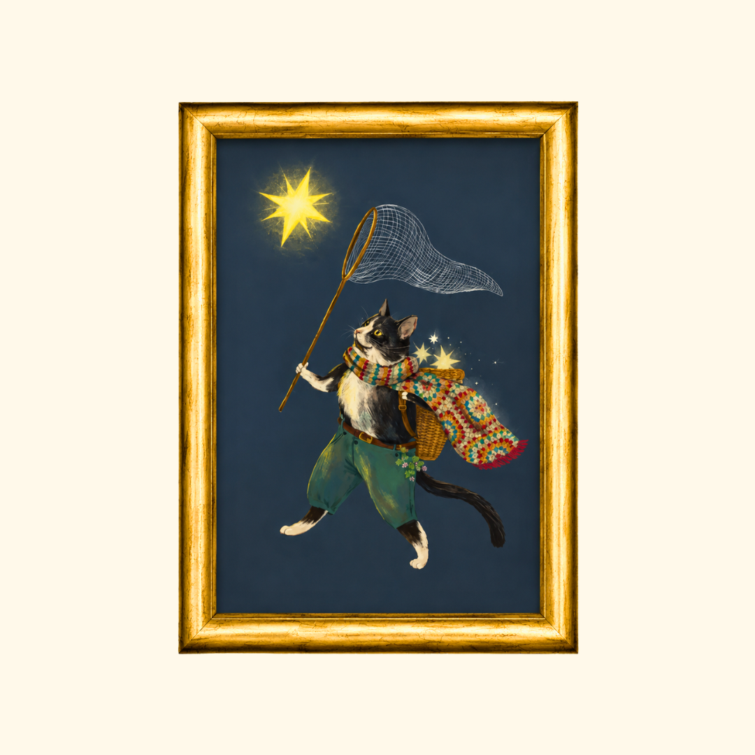 Ashy Cat greeting card displayed in a gold frame, showcasing the enchanting illustration of a caped cat carrying a basket on his back and reaching for glowing stars with a fishing net.