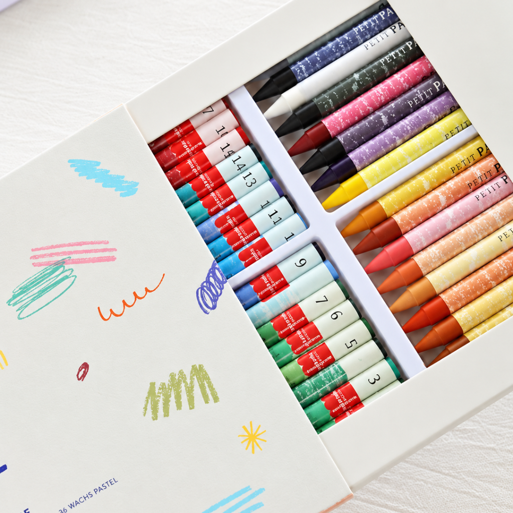 Box of colourful wax pastels arranged beside a practice sheet with pastel colour samples for the Autumn Stroll Pastels By Numbers Kit.