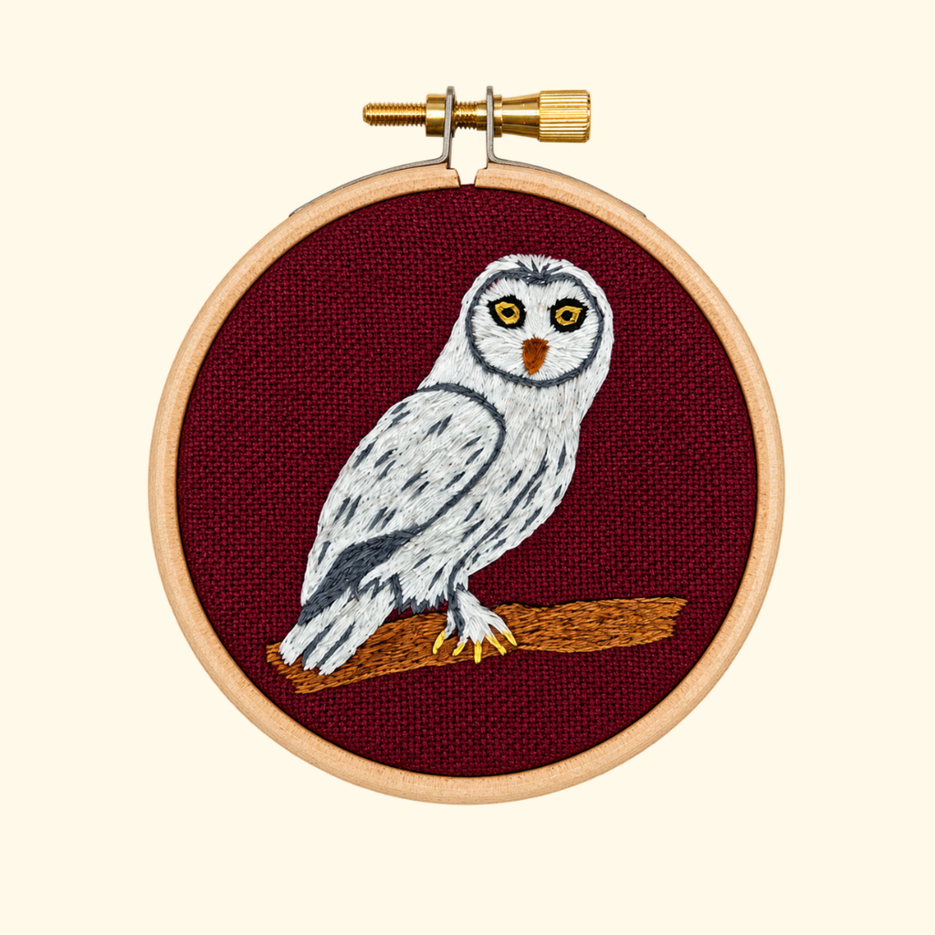 Finished Snowy Owl Mini Embroidery Kit by Paraffle displayed in a wooden embroidery hoop