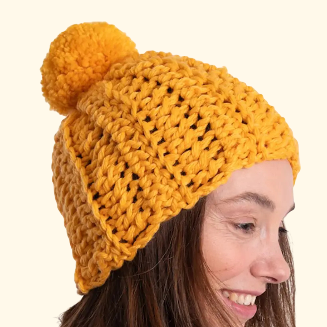 Model wearing the completed crocheted beanie made with the Wool Couture Beanie Crochet Kit.