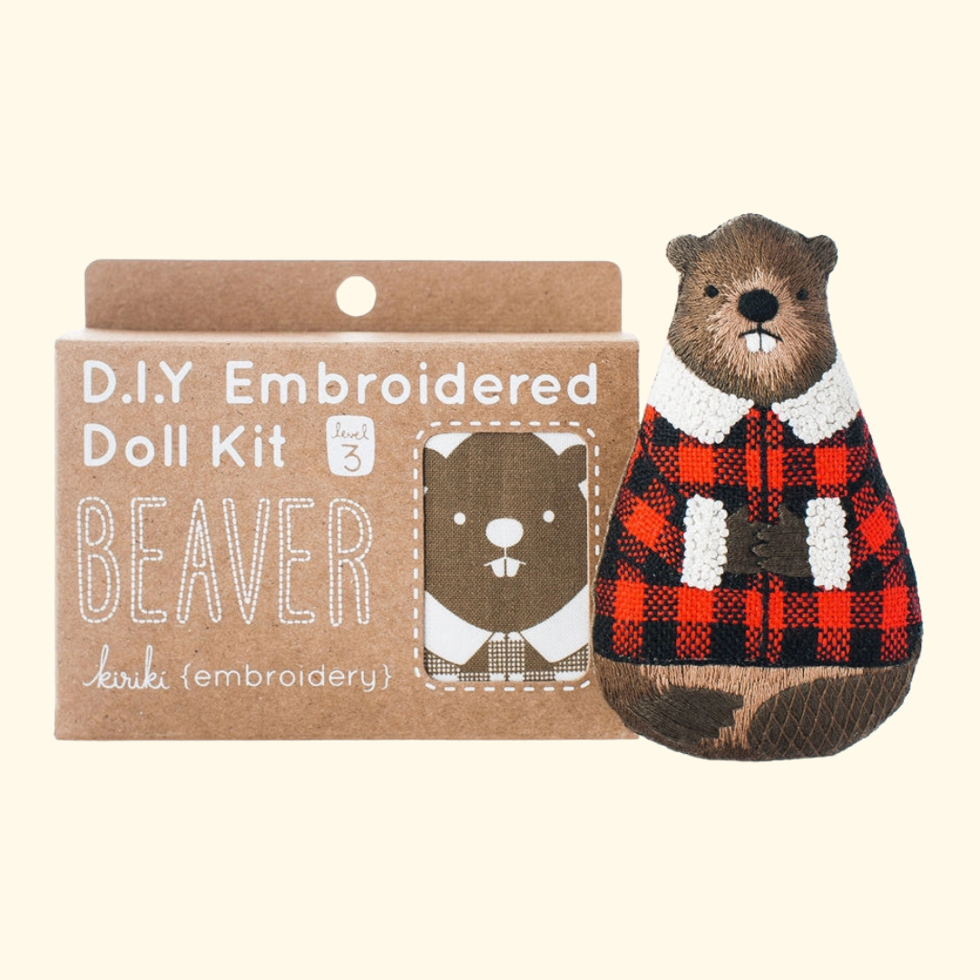 Beaver Embroidery Kit by Kiriki Press shown with the finished doll and kit packaging.