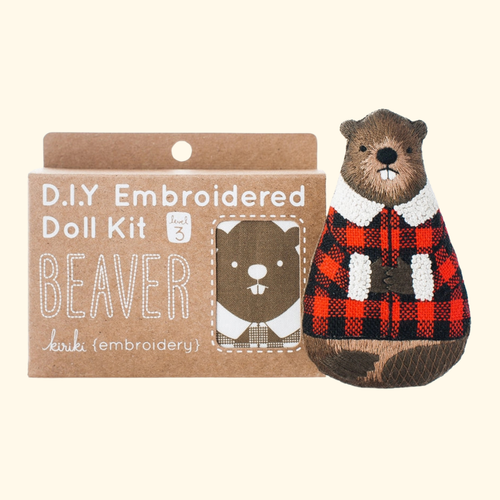 Beaver Embroidery Kit by Kiriki Press shown with the finished doll and kit packaging.