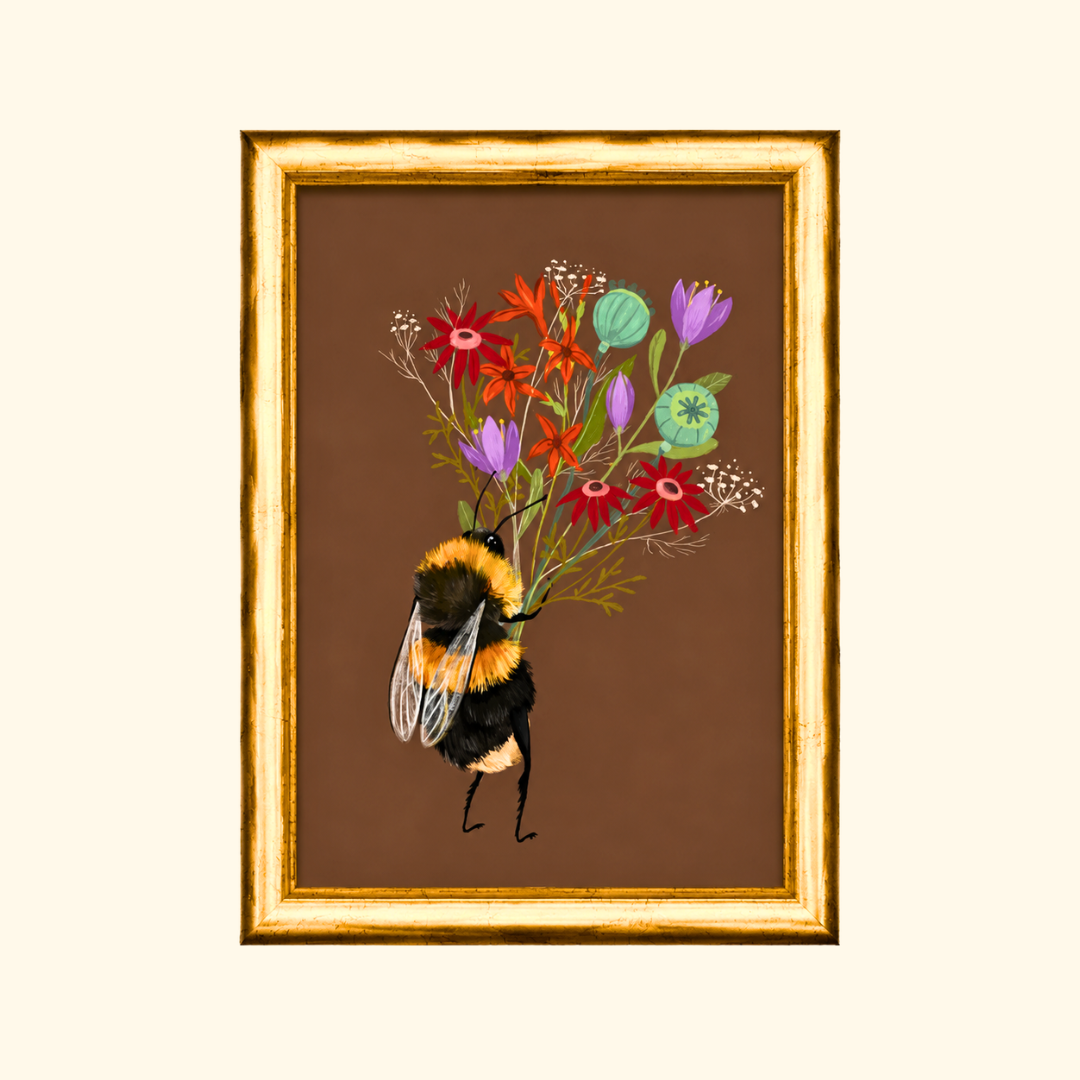 Bee With A Posy greeting card displayed in a gold frame, showcasing the whimsical illustration of a bumblebee carrying a colourful posy of wildflowers.
