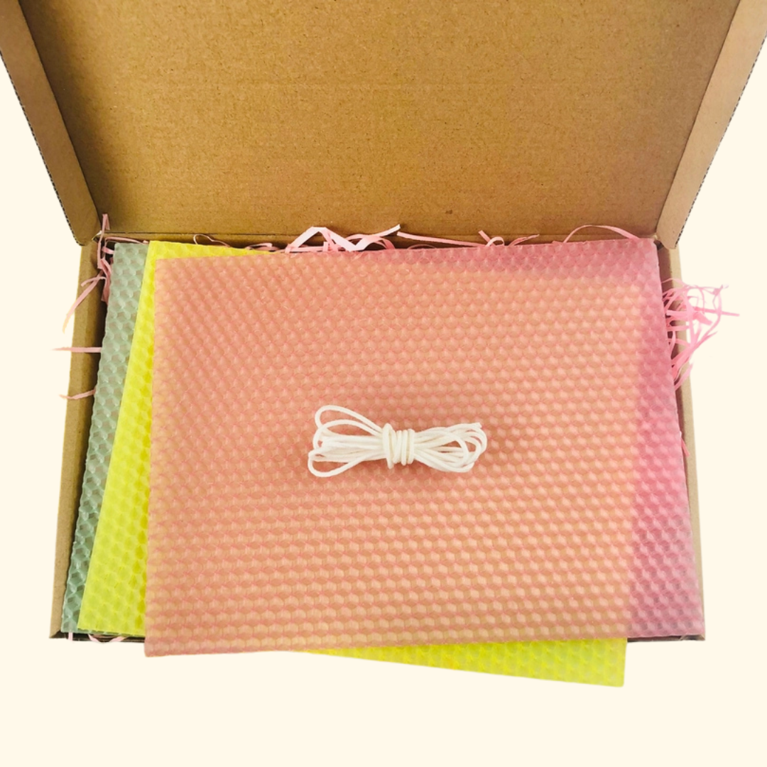 Contents of The Edinburgh Craft Club Beeswax Rolled Candle Making Kit neatly packaged with beeswax sheets and candle making materials.