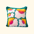 Finished Bloomin Lovely latch hook cushion featuring a colourful contemporary floral design.