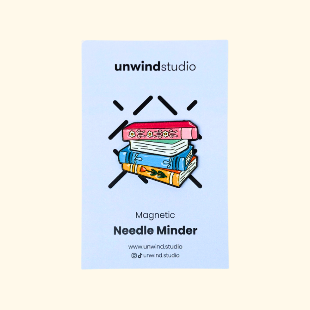 Book Lovers magnetic needle minder by Unwind Studio shown in its branded packaging.