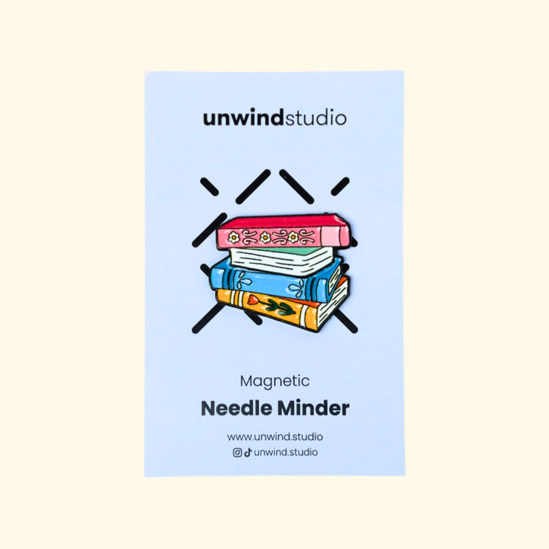Book Lovers magnetic needle minder by Unwind Studio shown in its branded packaging.