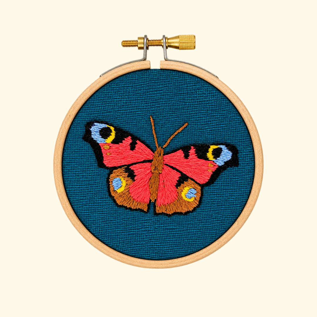 Finished Butterfly Mini Embroidery Kit by Paraffle displayed in a wooden embroidery hoop.