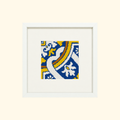 Finished Cedofeita needlepoint design featuring a blue, white and yellow Portuguese tile pattern in a cream frame.