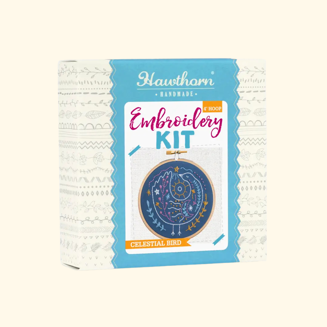 Celestial Bird Mini Embroidery Kit by Hawthorn Handmade with kit packaging and finished celestial bird embroidery hoop.