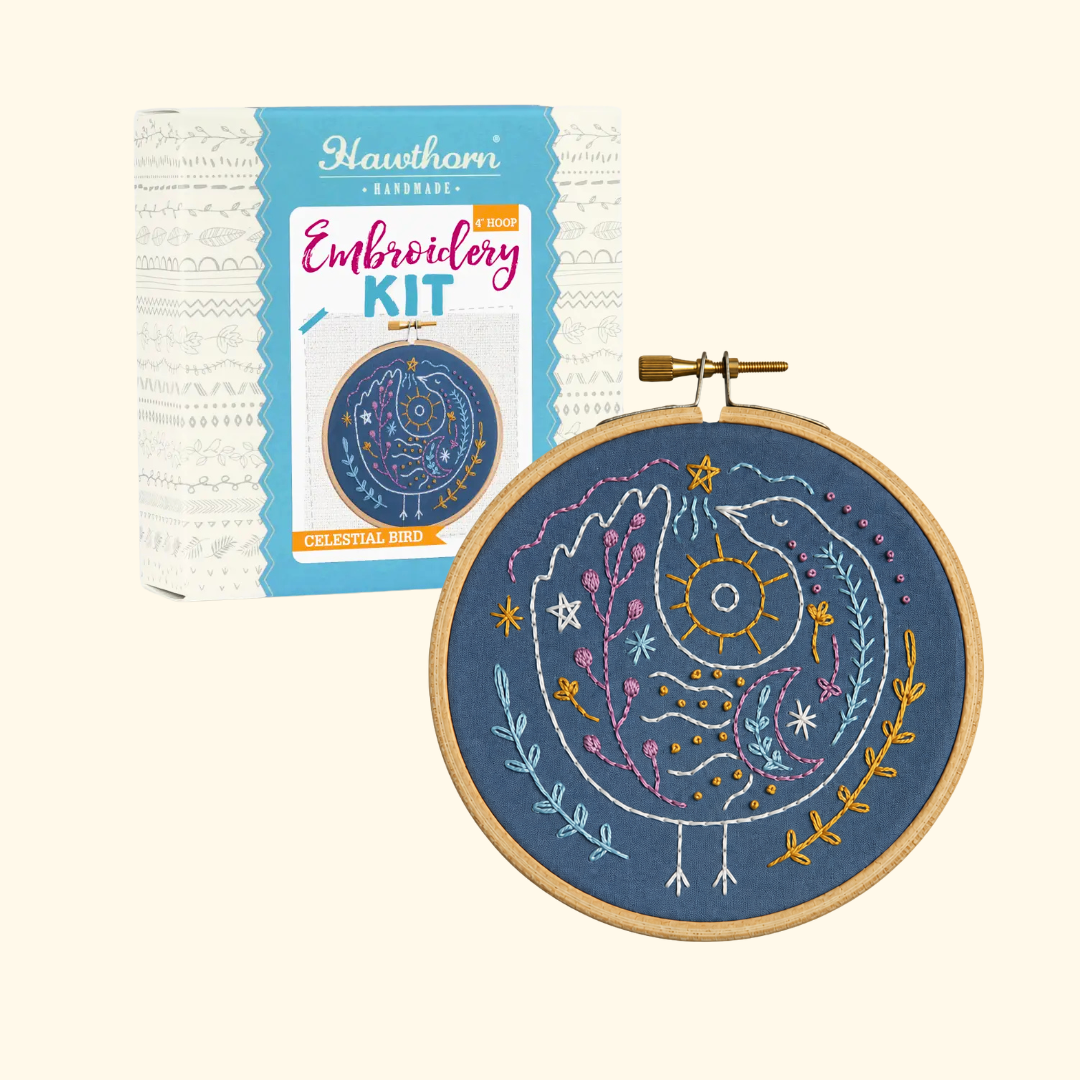 Celestial Bird Mini Embroidery Kit by Hawthorn Handmade shown with kit packaging and finished embroidery hoop.