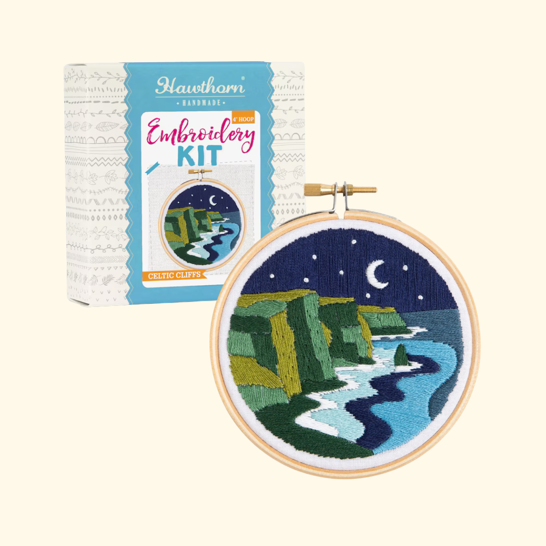 Celtic Cliffs Mini Embroidery Kit by Hawthorn Handmade showing both the gift box and completed embroidered coastal landscape artwork.