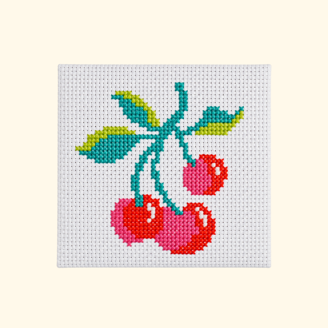 Completed Cherries Mini Cross Stitch Kit design featuring three red cherries with green leaves.