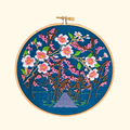Finished Cherry Blossom Embroidery Kit by Paraffle displayed in a wooden embroidery hoop.