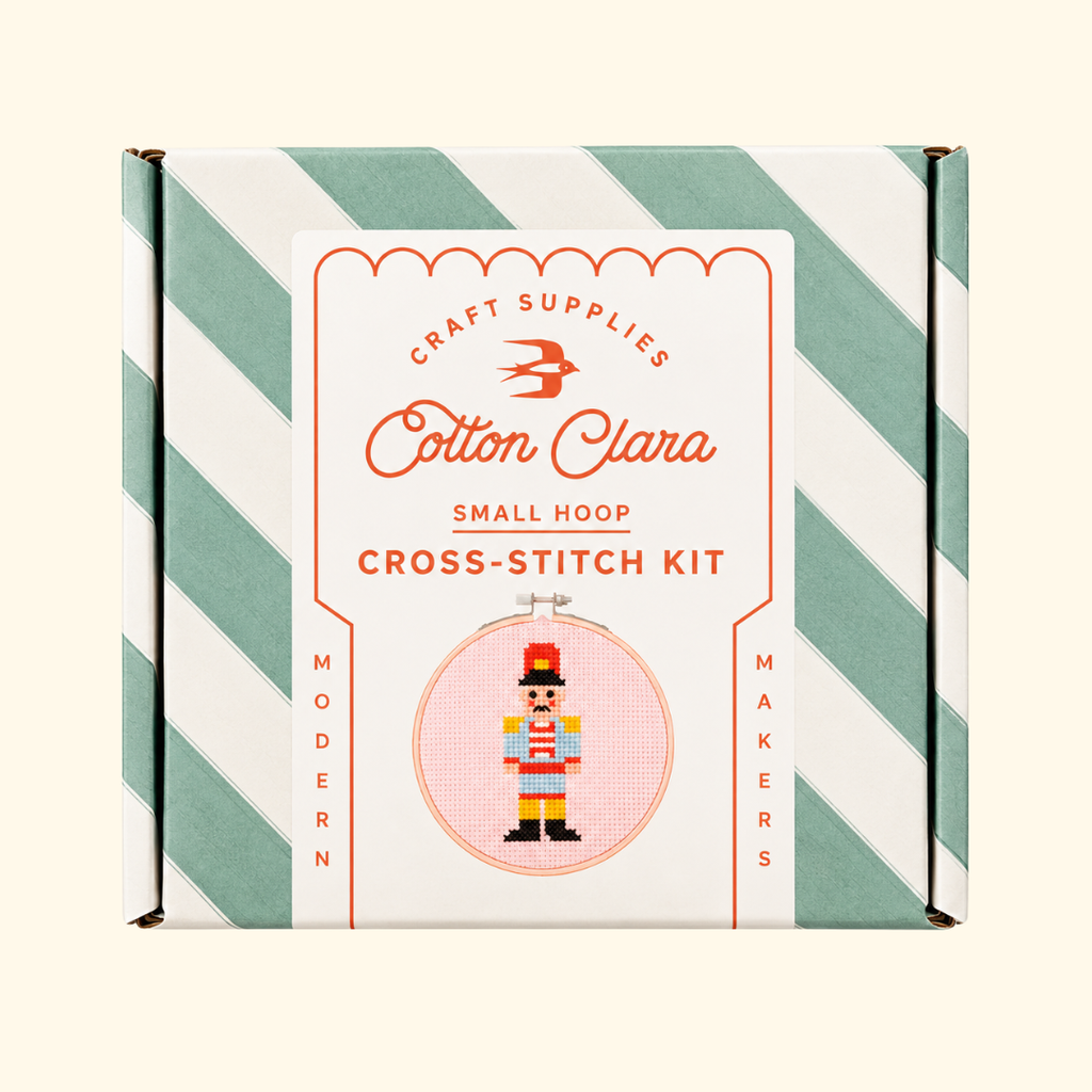 Cotton Clara Christmas Nutcracker Cross Stitch Kit in its mint green and white striped presentation box.