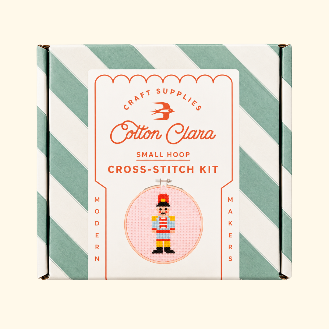 Cotton Clara Christmas Nutcracker Cross Stitch Kit in its mint green and white striped presentation box.
