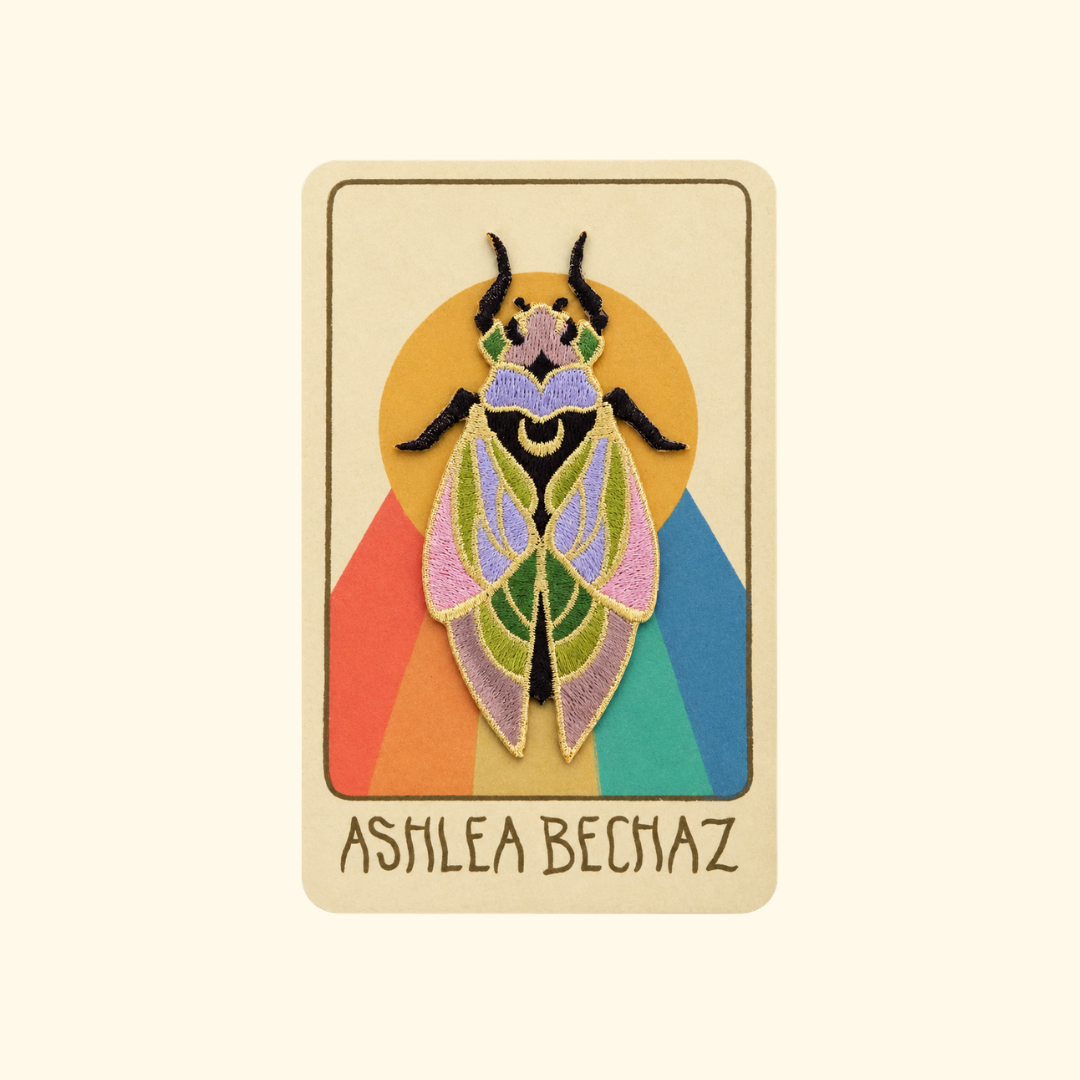 Cicada Embroidered Iron On Patch by Ashlea Bechaz Illustration displayed on illustrated backing card against a cream background.