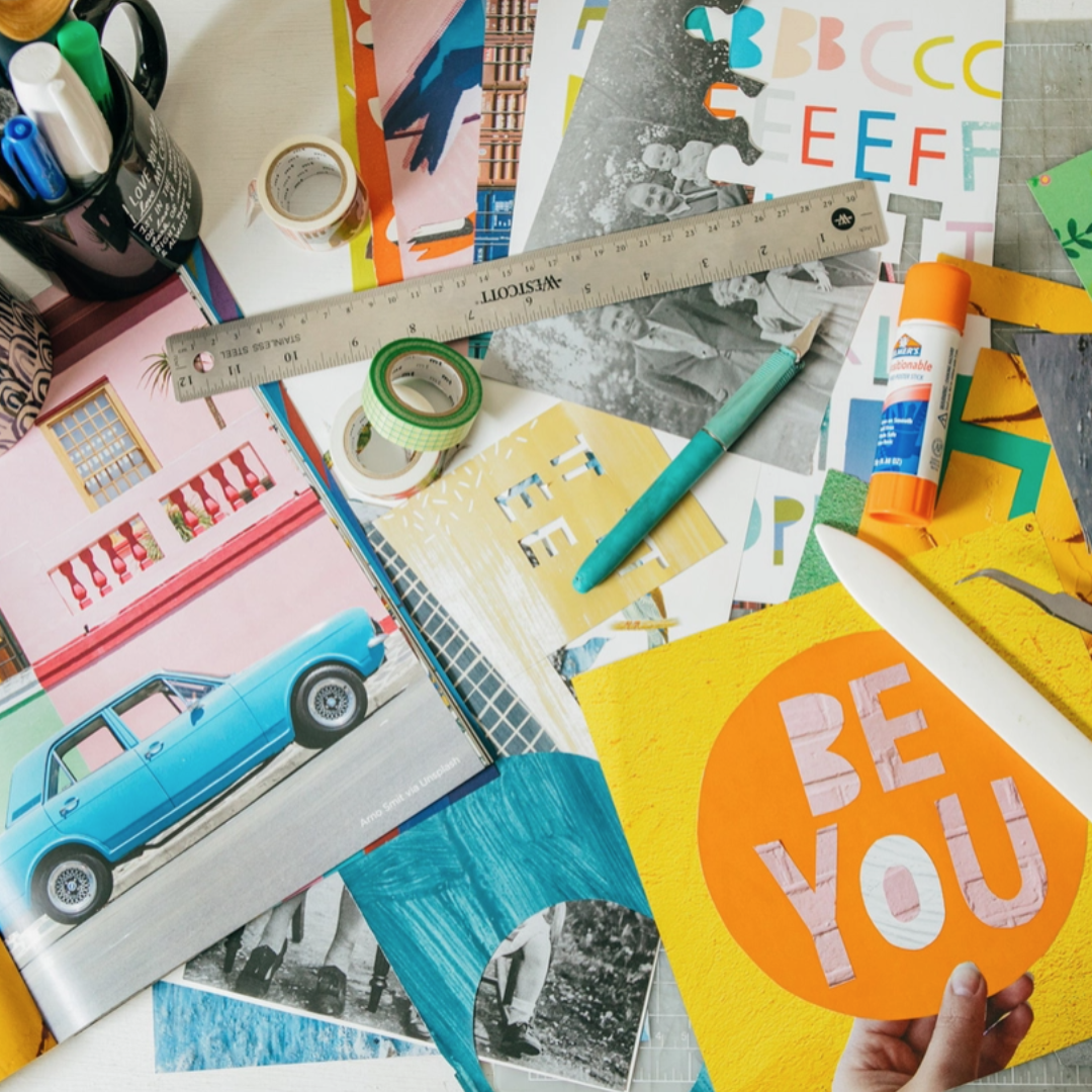 Collage workspace with pages from Collage Kit Magazine Vol. 1, scissors, rulers, glue and paper cuttings
