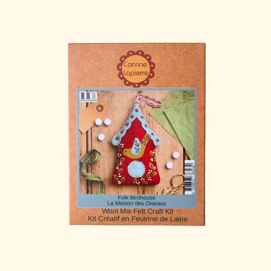 Corinne Lopierre Folk Birdhouse Wool Mix Felt Craft Kit in its original brown cardboard packaging, featuring a photo of the completed red felt birdhouse with a yellow bird on the front.