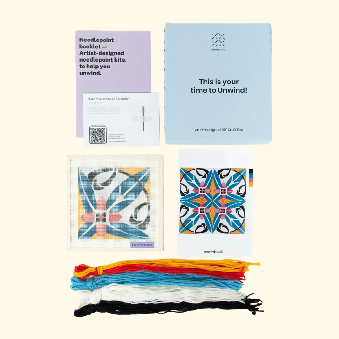 Costa Cabral needlepoint kit contents with printed canvas, DMC threads, needles, instructions and colour guide.