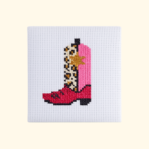 Completed Cowgirl Boot Mini Cross Stitch Kit featuring a pink and leopard print cowboy boot by The Make Arcade.