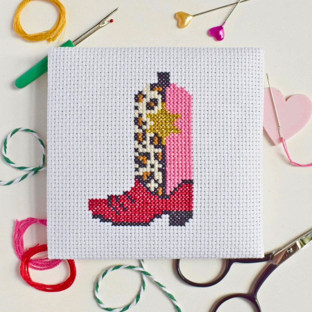 Cowgirl Boot Mini Cross Stitch Kit in progress stitched on white Aida fabric.