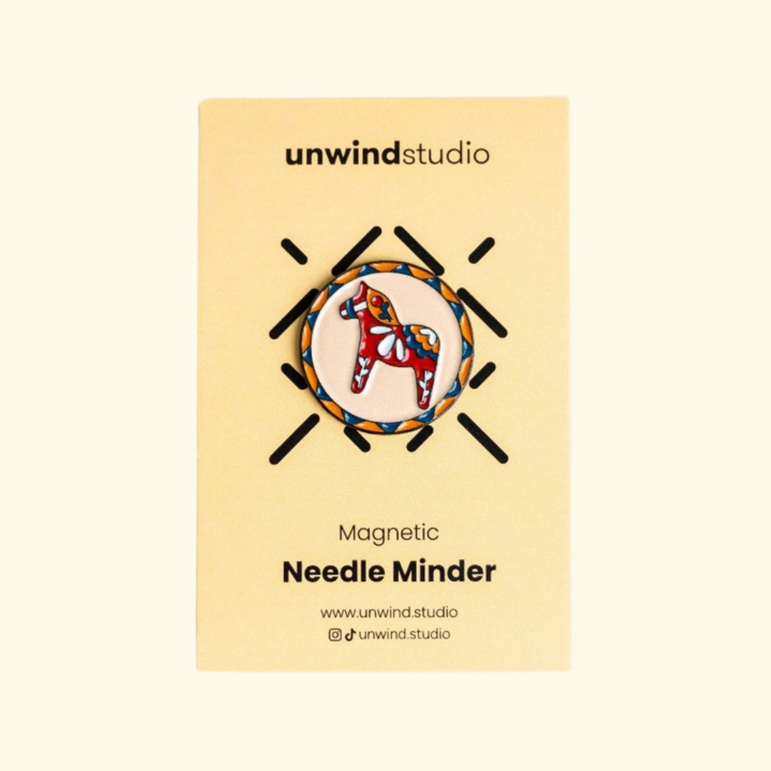 Dala Horse Magnetic Needle Minder by Unwind Studio displayed on its cream packaging card.
