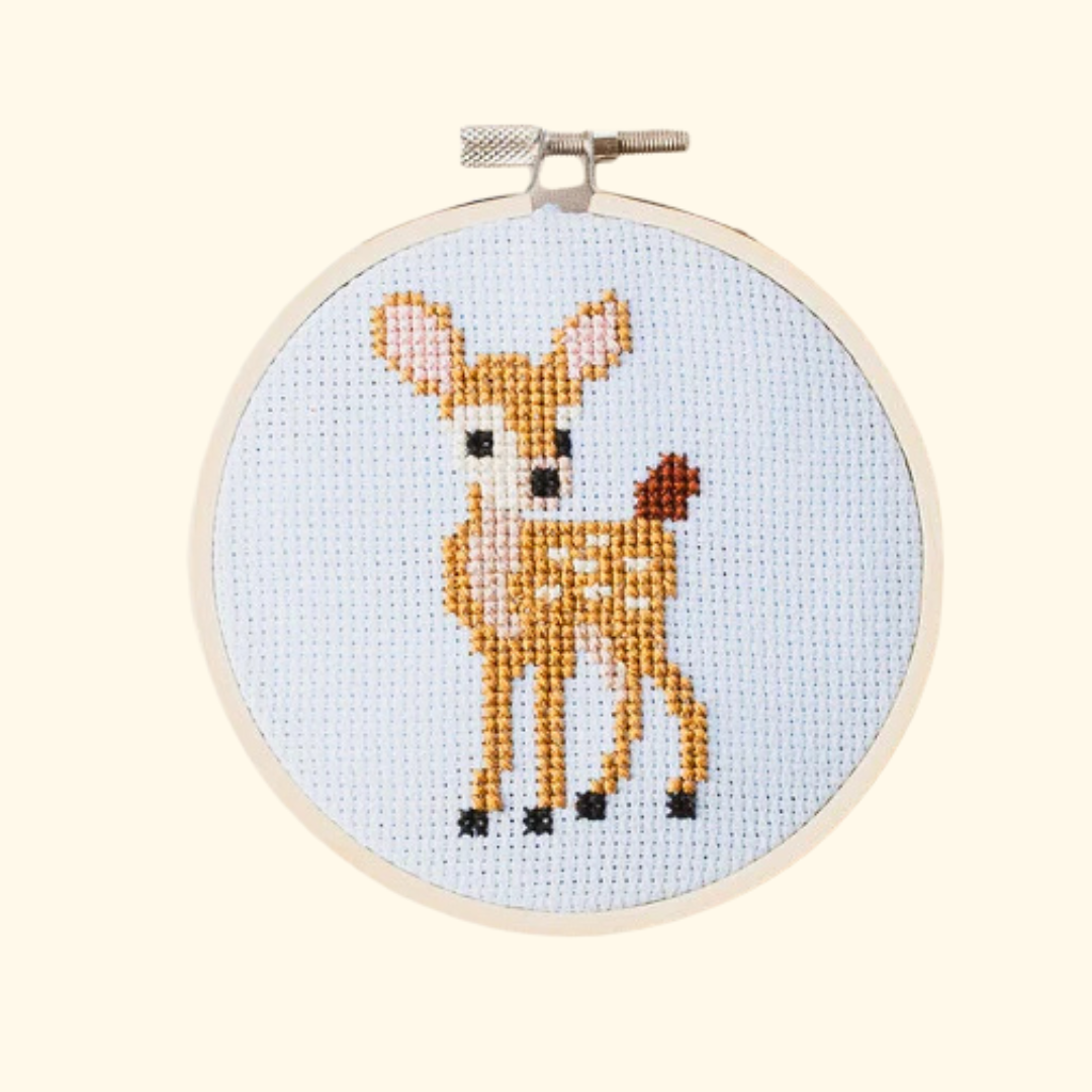 Completed deer cross stitch design stitched in an embroidery hoop by Cotton Clara.