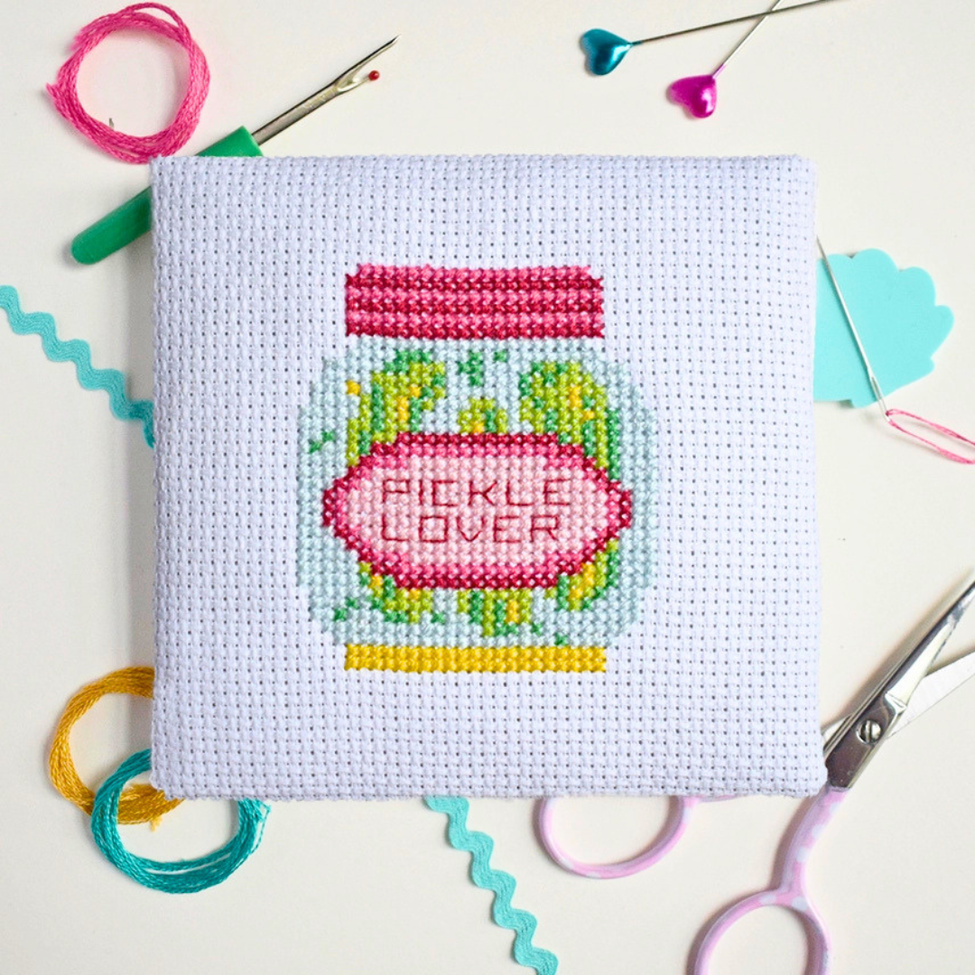 Dill Pickle Mini Cross Stitch Kit in progress stitched on white Aida fabric.
