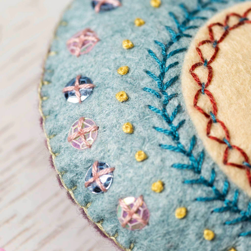Close up of decorative embroidery and blanket stitching on the Embroidered Heart felt craft kit by Corinne Lapierre.