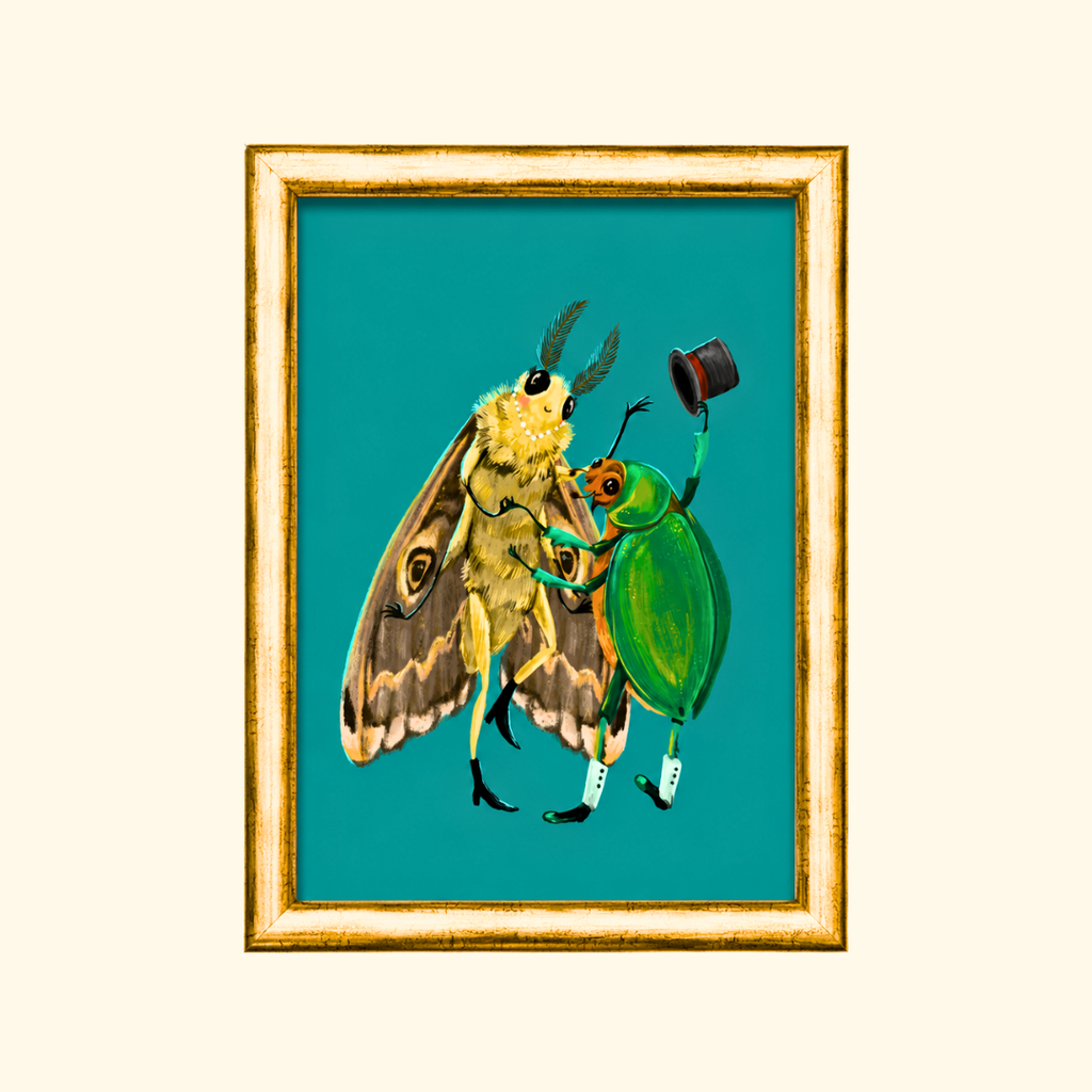 Fancy Dancing greeting card displayed in a gold frame, showcasing the charming illustration of a moth lady dancing with a beetle gent holding his top hat.