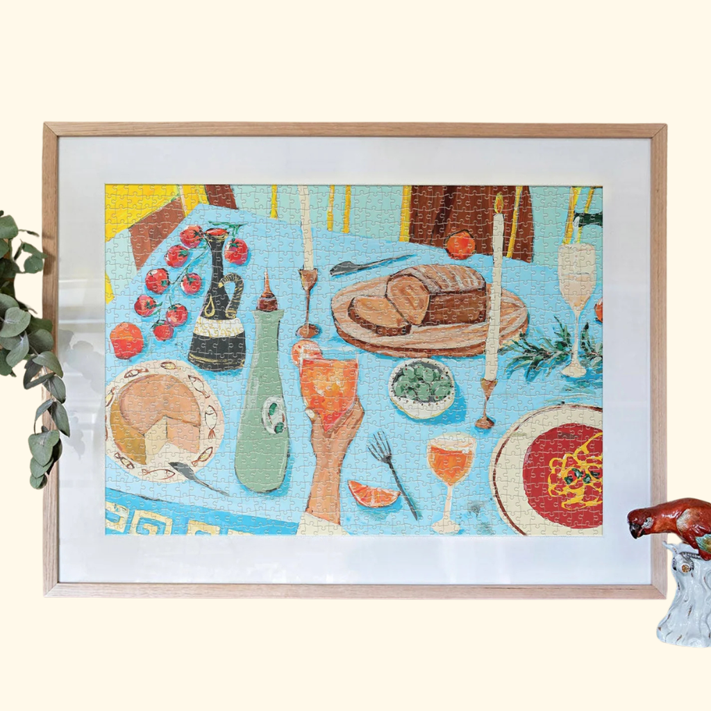 Framed Feast on the Sunlit Terrace puzzle displayed as wall art in a light timber frame.