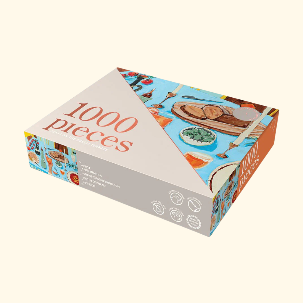 Packaging for the Feast on the Sunlit Terrace 1000 piece puzzle by Journey of Something.