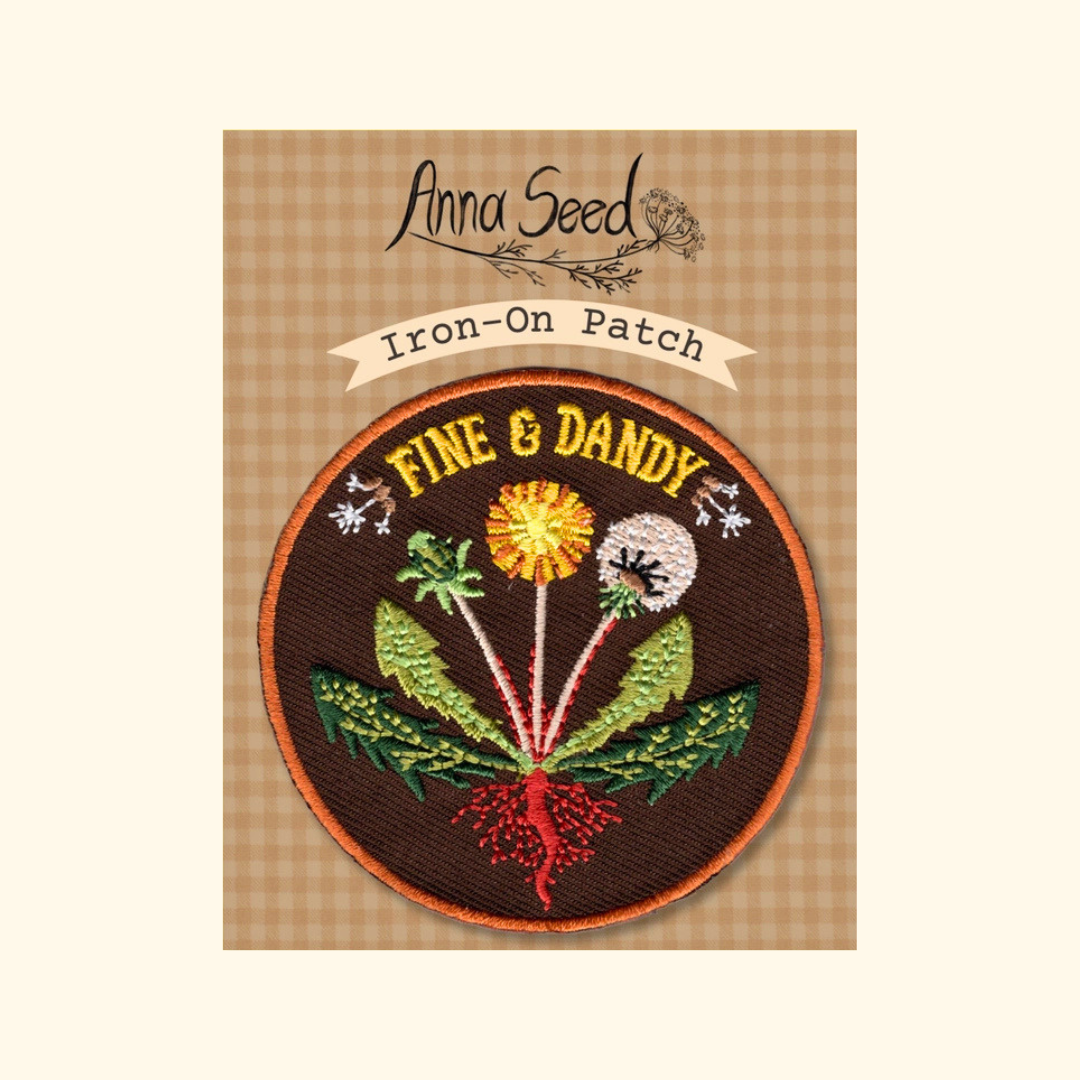 Packaged Fine & Dandy embroidered iron on patch by Anna Seed Art displayed on its backing card.