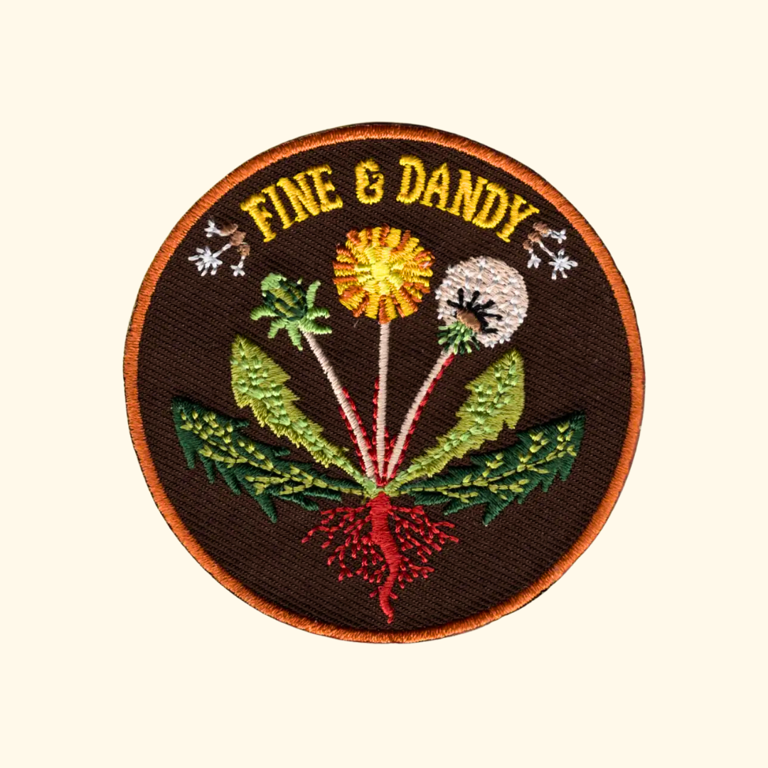 Fine & Dandy embroidered iron on patch by Anna Seed Art featuring colourful dandelions and wildflowers with the words "Fine & Dandy".