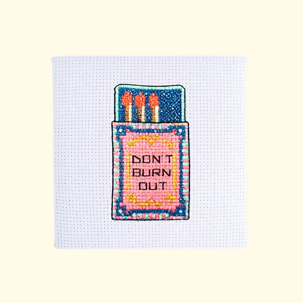Completed Flamin Hot Mini Cross Stitch Kit featuring a colourful hot sauce bottle design by The Make Arcade.