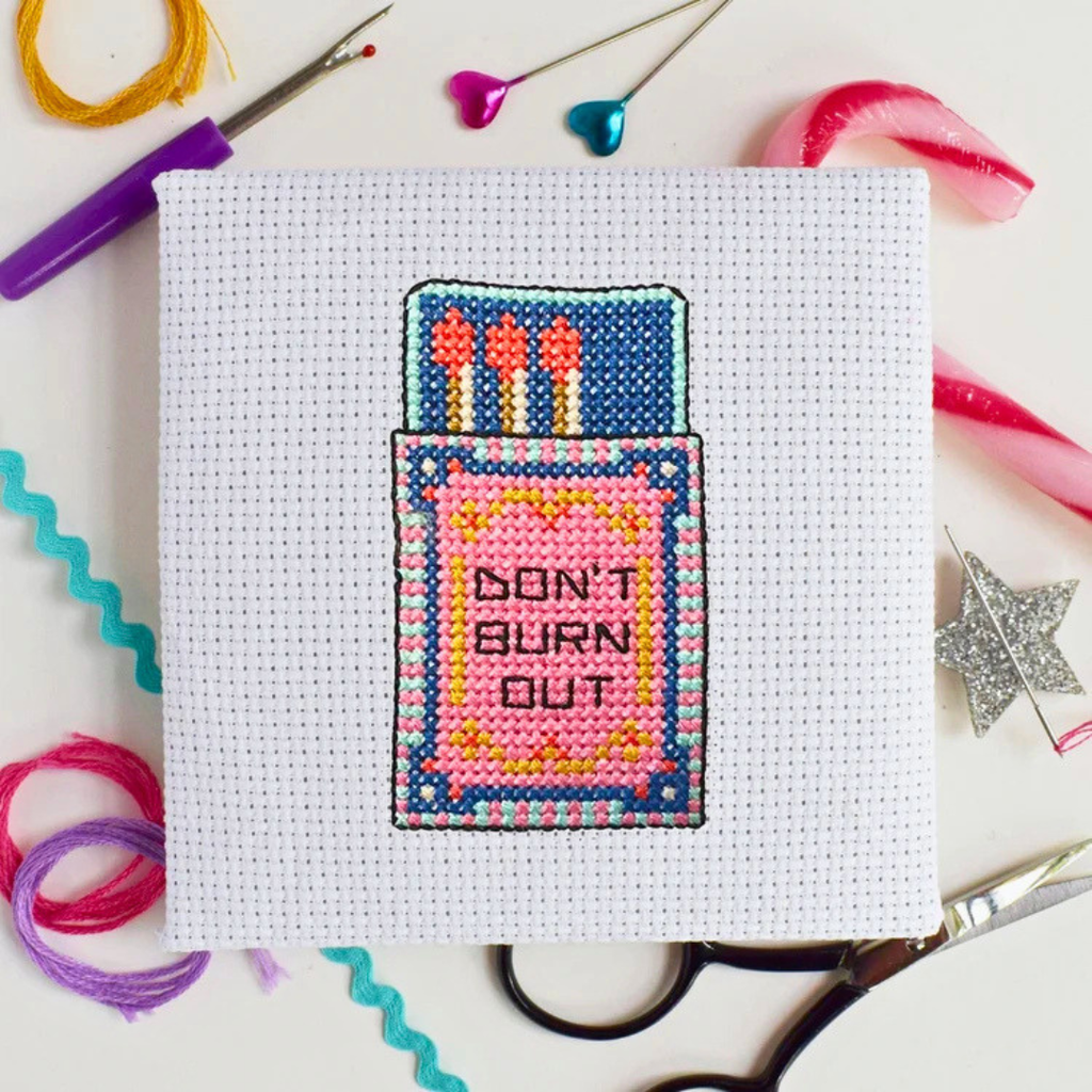 Flamin Hot Mini Cross Stitch Kit in progress stitched on white Aida fabric.