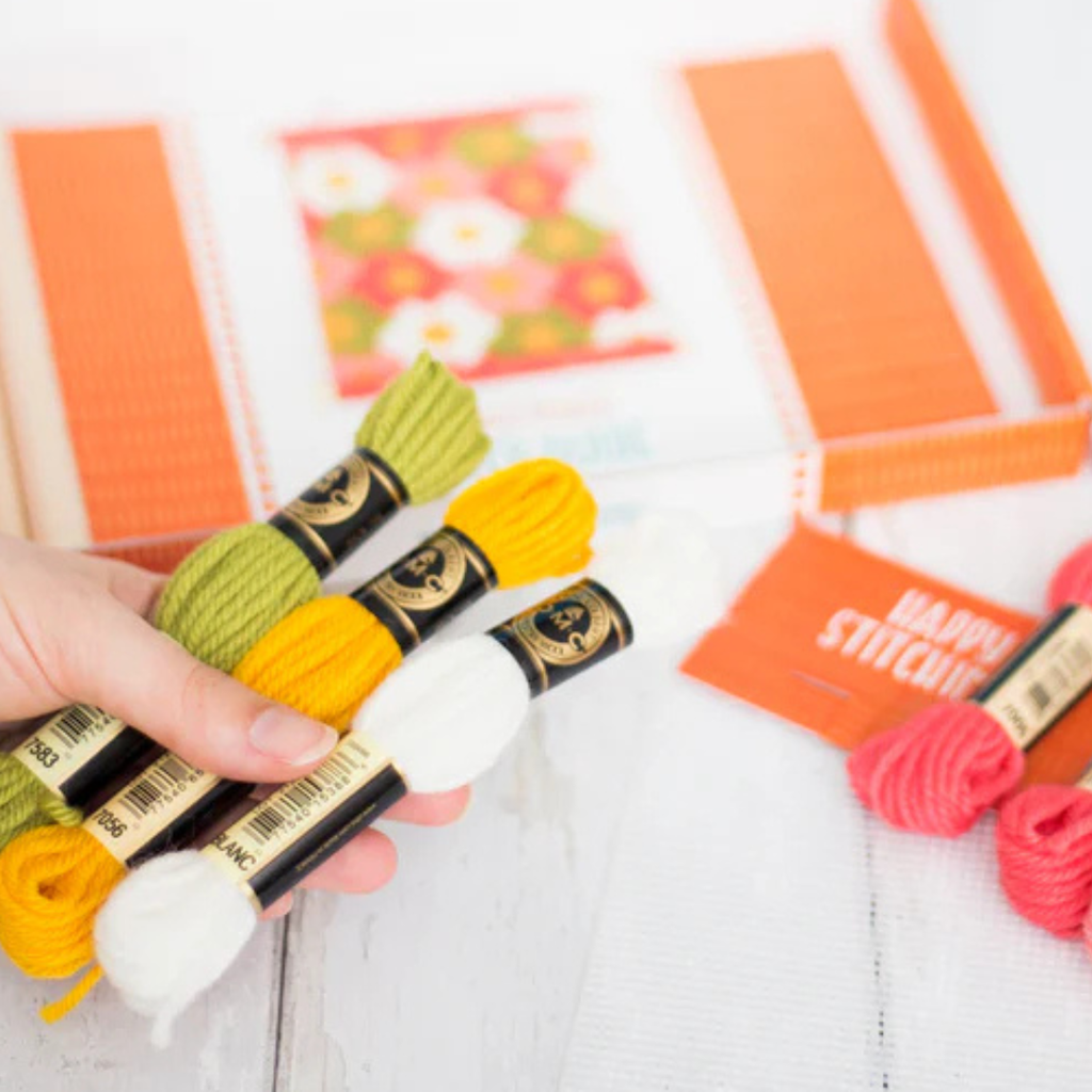 Flower Power Bargello Wall Hanging Kit displayed in a crafting workspace with tapestry wool and stitching supplies