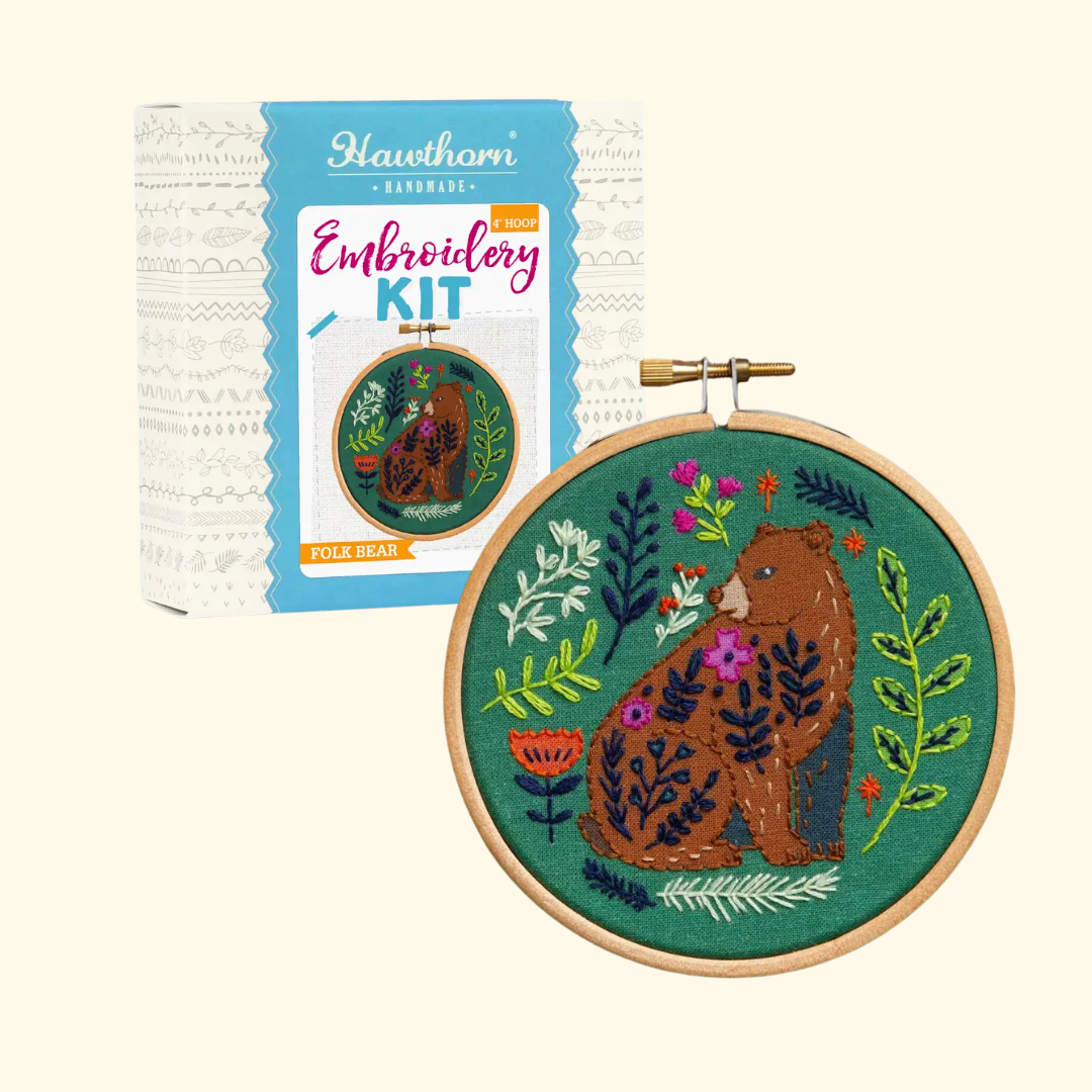 Folk Bear Mini Embroidery Kit by Hawthorn Handmade shown with kit packaging and the finished embroidery hoop.