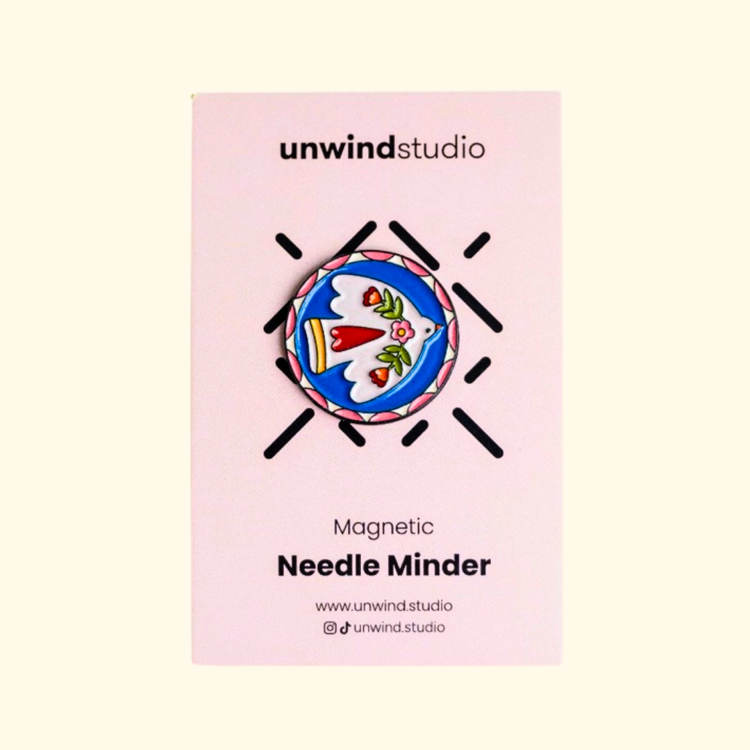 Folk Bird Magnetic Needle Minder by Unwind Studio displayed on its pink packaging card.