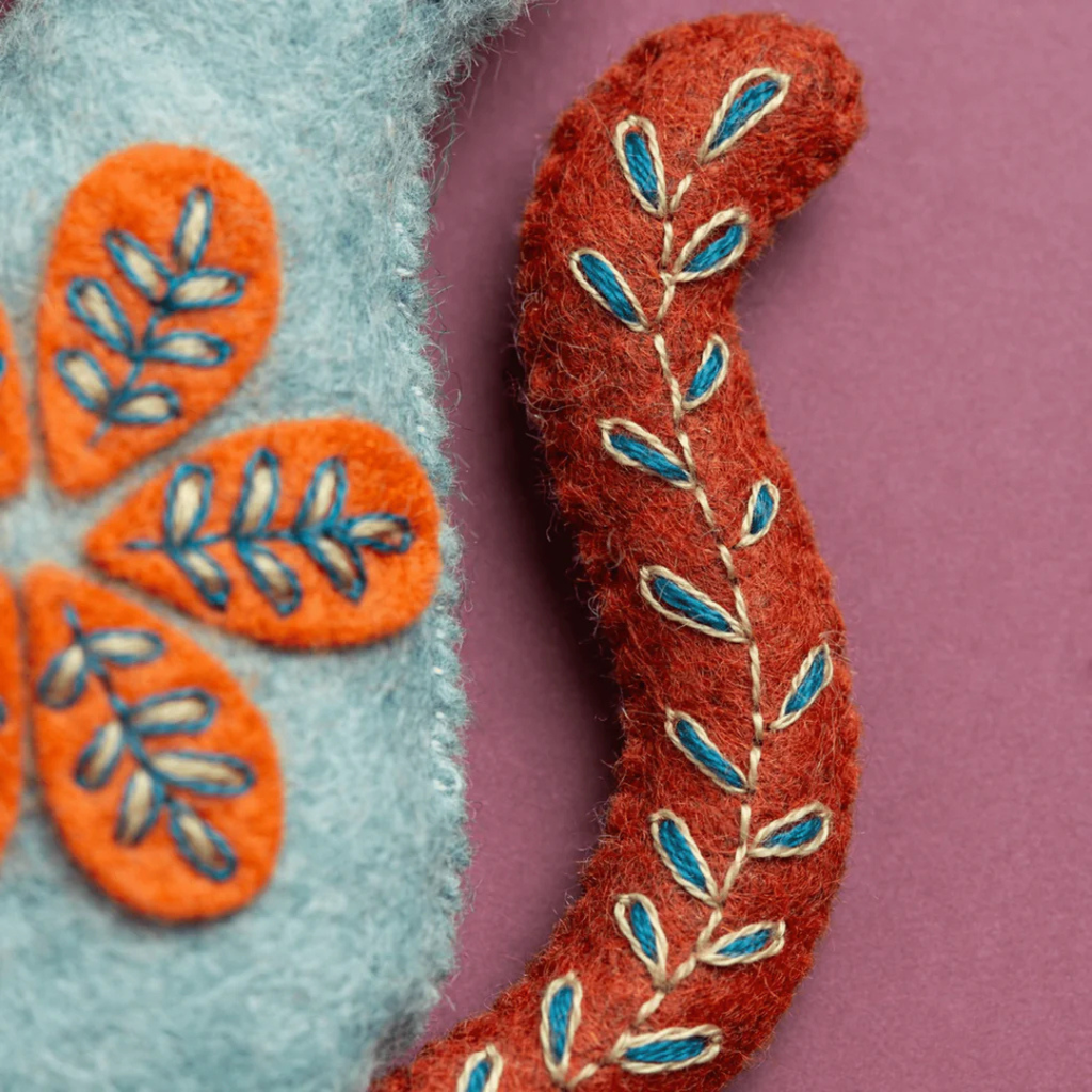 Close up of the embroidered face details on the Folk Cat felt craft kit by Corinne Lapierre.