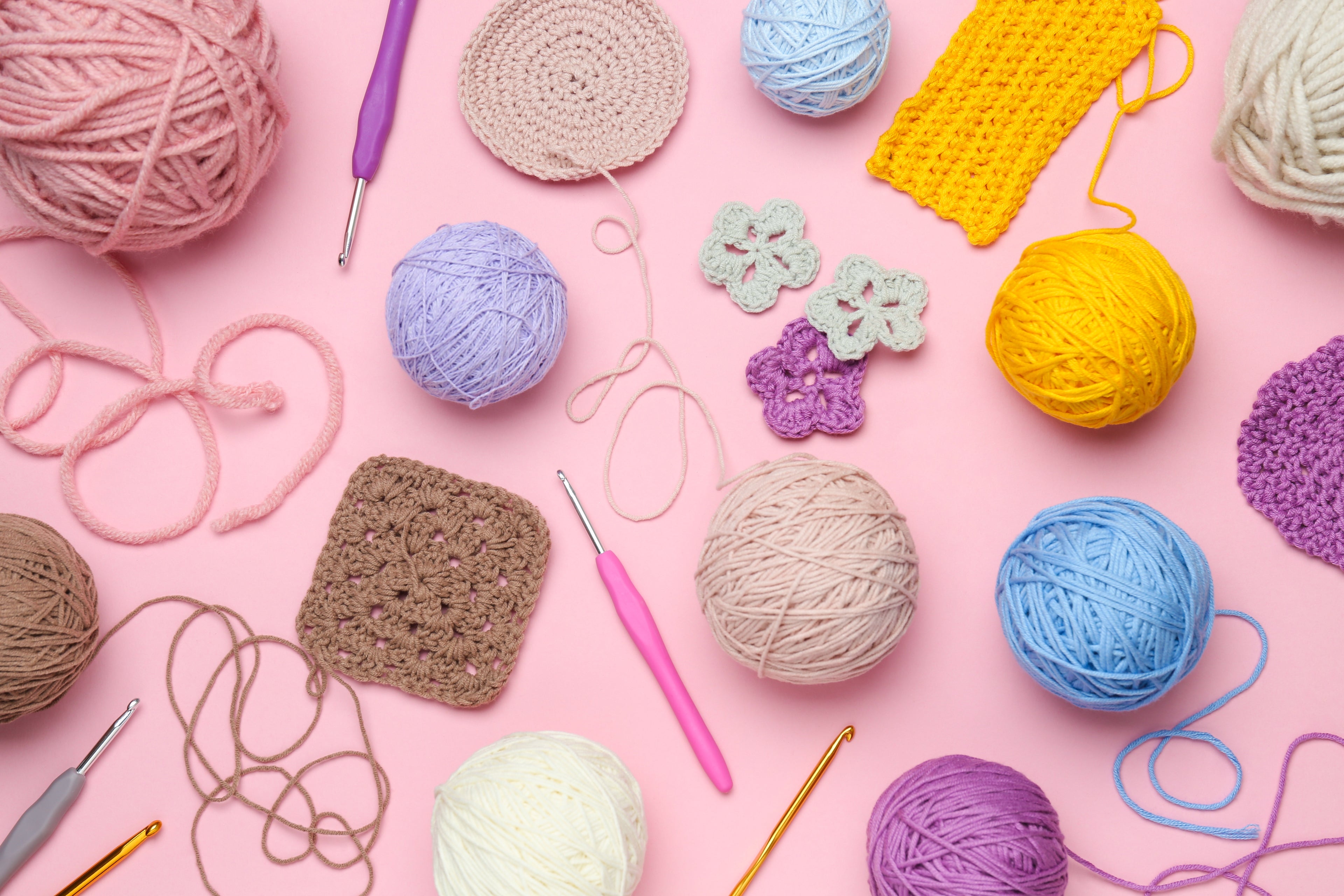 Colourful yarn, crochet hooks and handmade craft projects representing beginner friendly craft kits and creative hobbies.