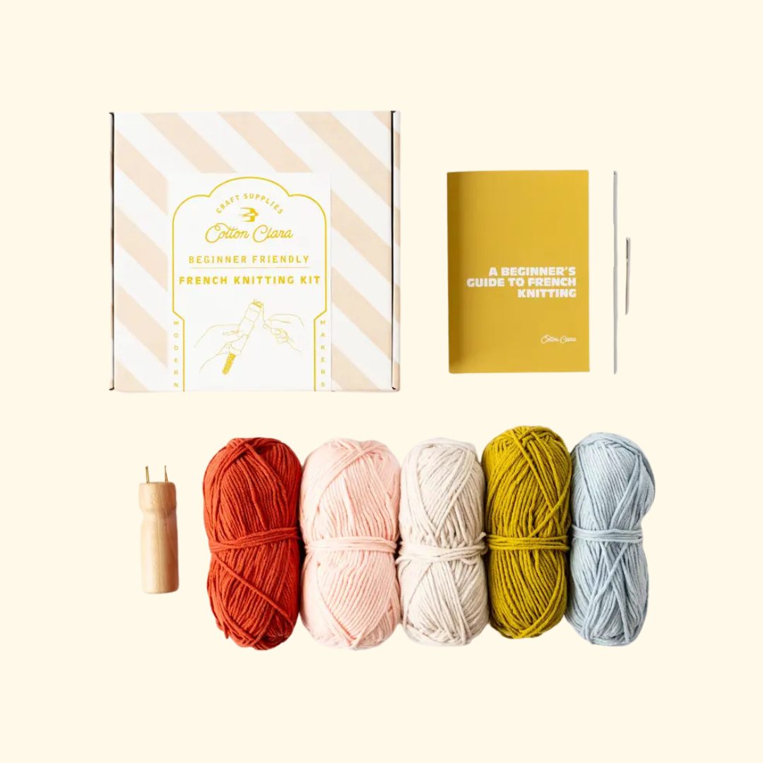 Contents of the Cotton Clara French Knitting Kit including yarn, knitting tool, instructions and accessories.
