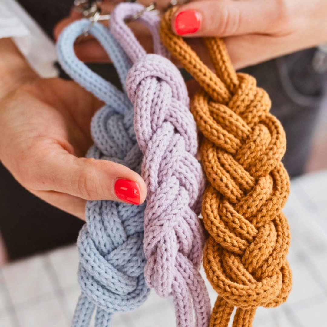 Close-up of a French knitting project in progress using chunky yarn.