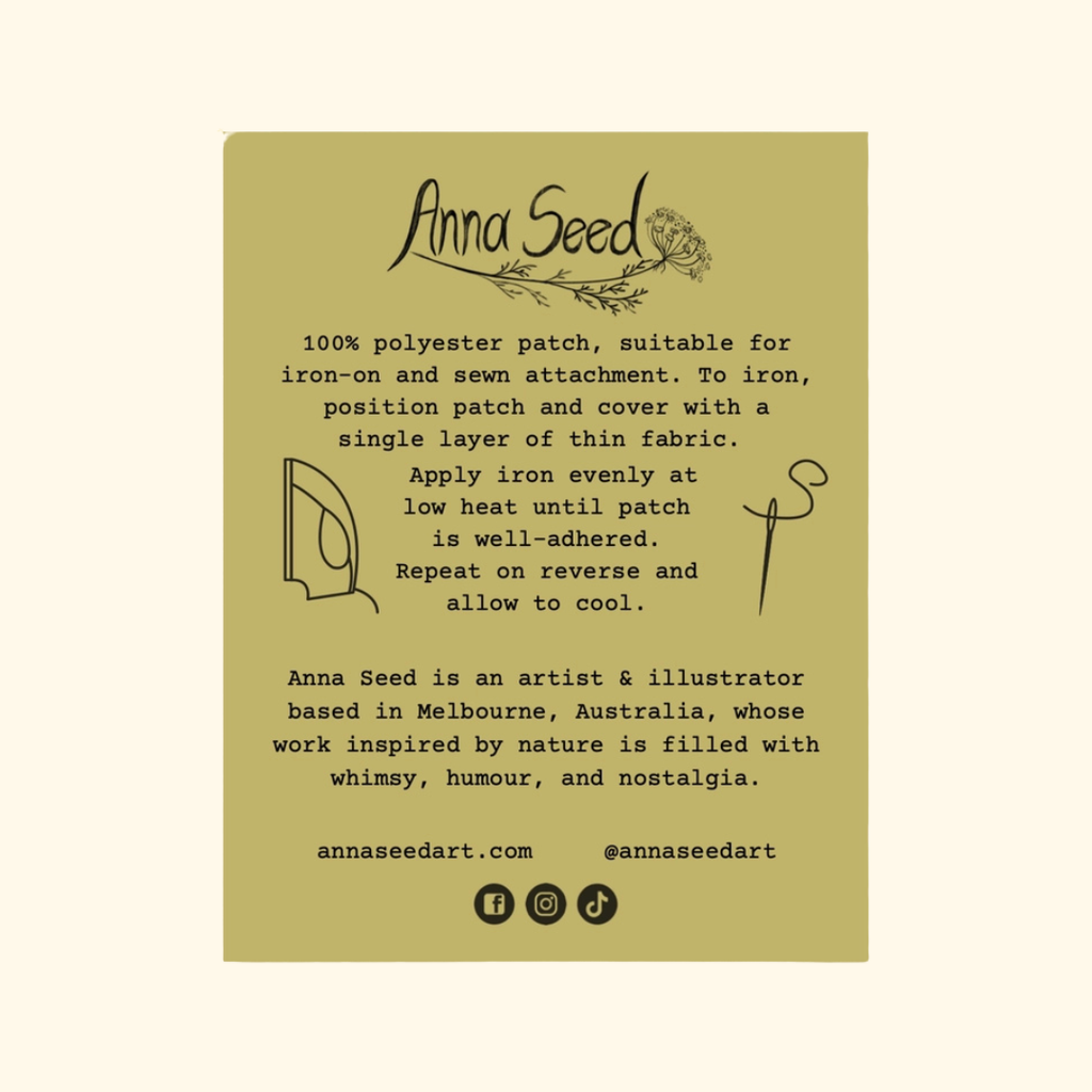 A rectangular olive green product card with black text and illustrations, reading 'Anna Seed' at the top and describing a polyester patch. The card is centered on a light cream background.