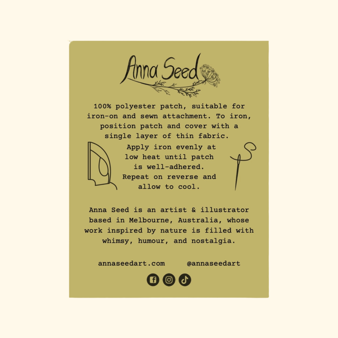 A rectangular olive green product card with black text and illustrations, reading 'Anna Seed' at the top and describing a polyester patch. The card is centered on a light cream background.